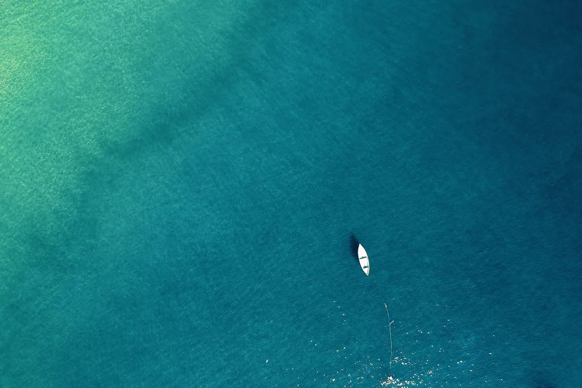 A striped surfboard leaning against a brightly painted wall